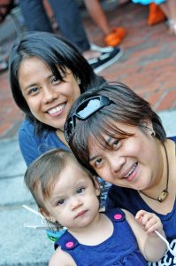 Lesbian couple with their daughter at Family Week in Provincetown